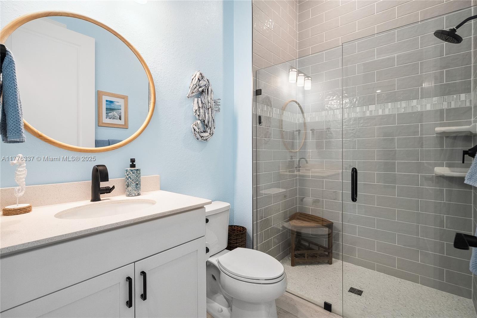9734 Southwest Meridian Way Stuart, FL 34997 - Photo 27 of 48 a bathroom with a sink mirror toilet and shower