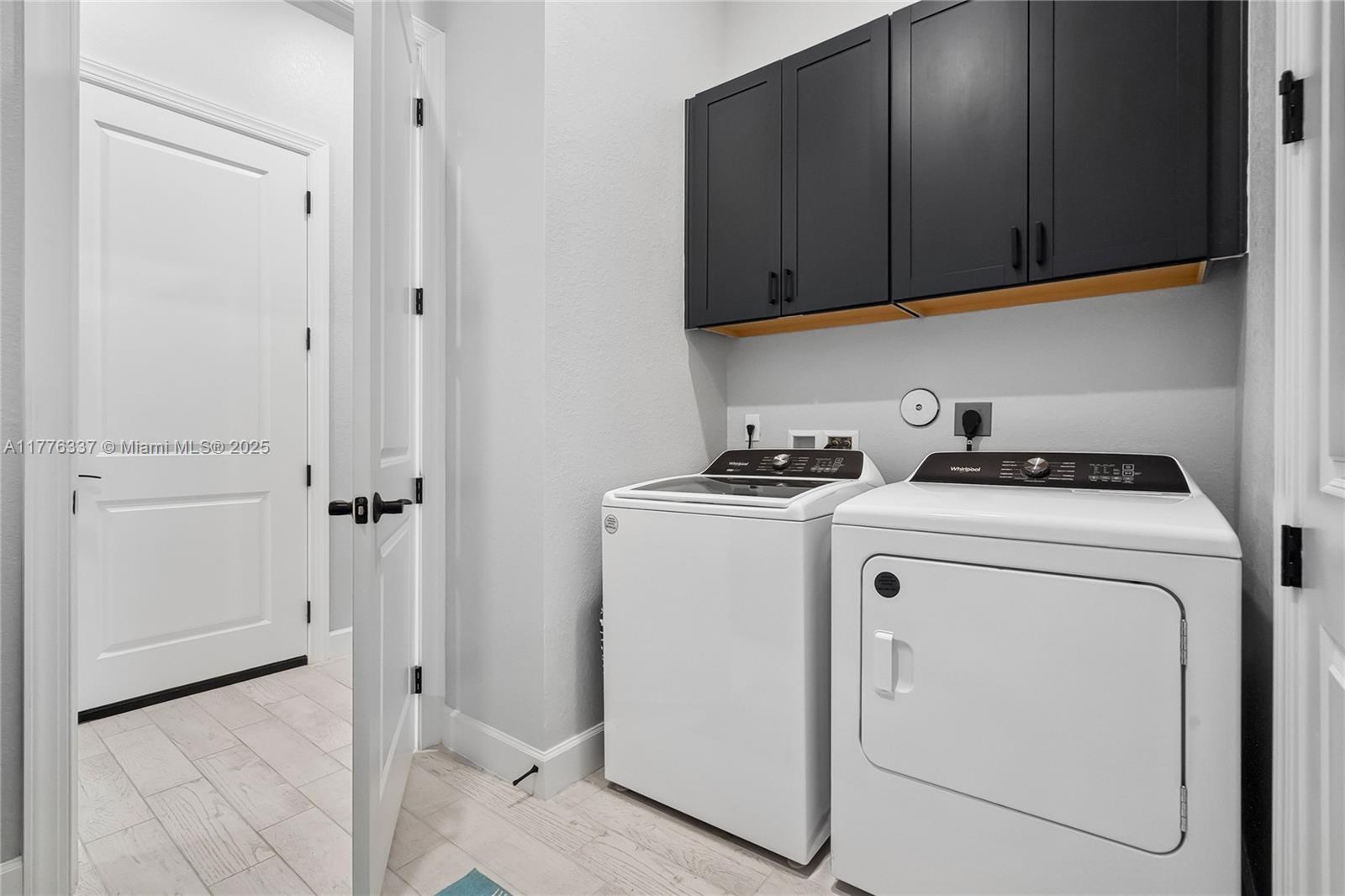 9734 Southwest Meridian Way Stuart, FL 34997 - Photo 31 of 48 a view of storage and utility room with washer and dryer