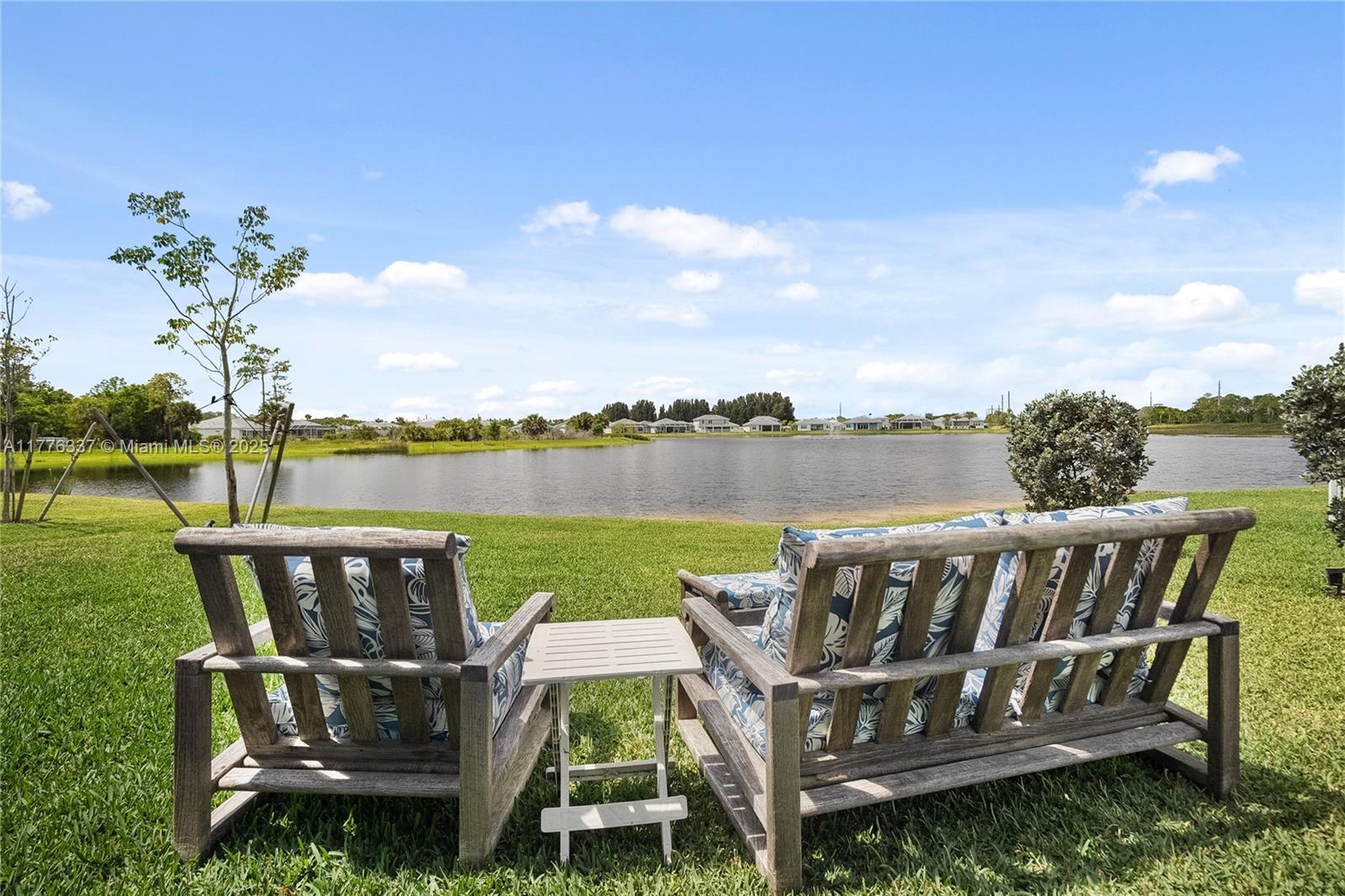 9734 Southwest Meridian Way Stuart, FL 34997 - Photo 38 of 48 a balcony with wooden floor outdoor seating and lake view