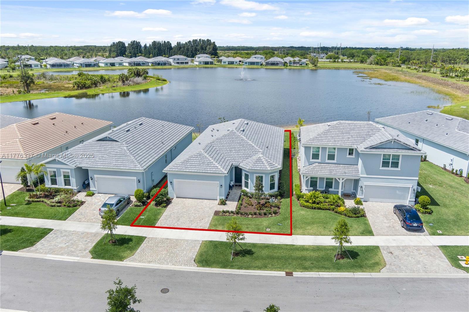 9734 Southwest Meridian Way Stuart, FL 34997 - Photo 47 of 48 an aerial view of a house with a garden and lake view