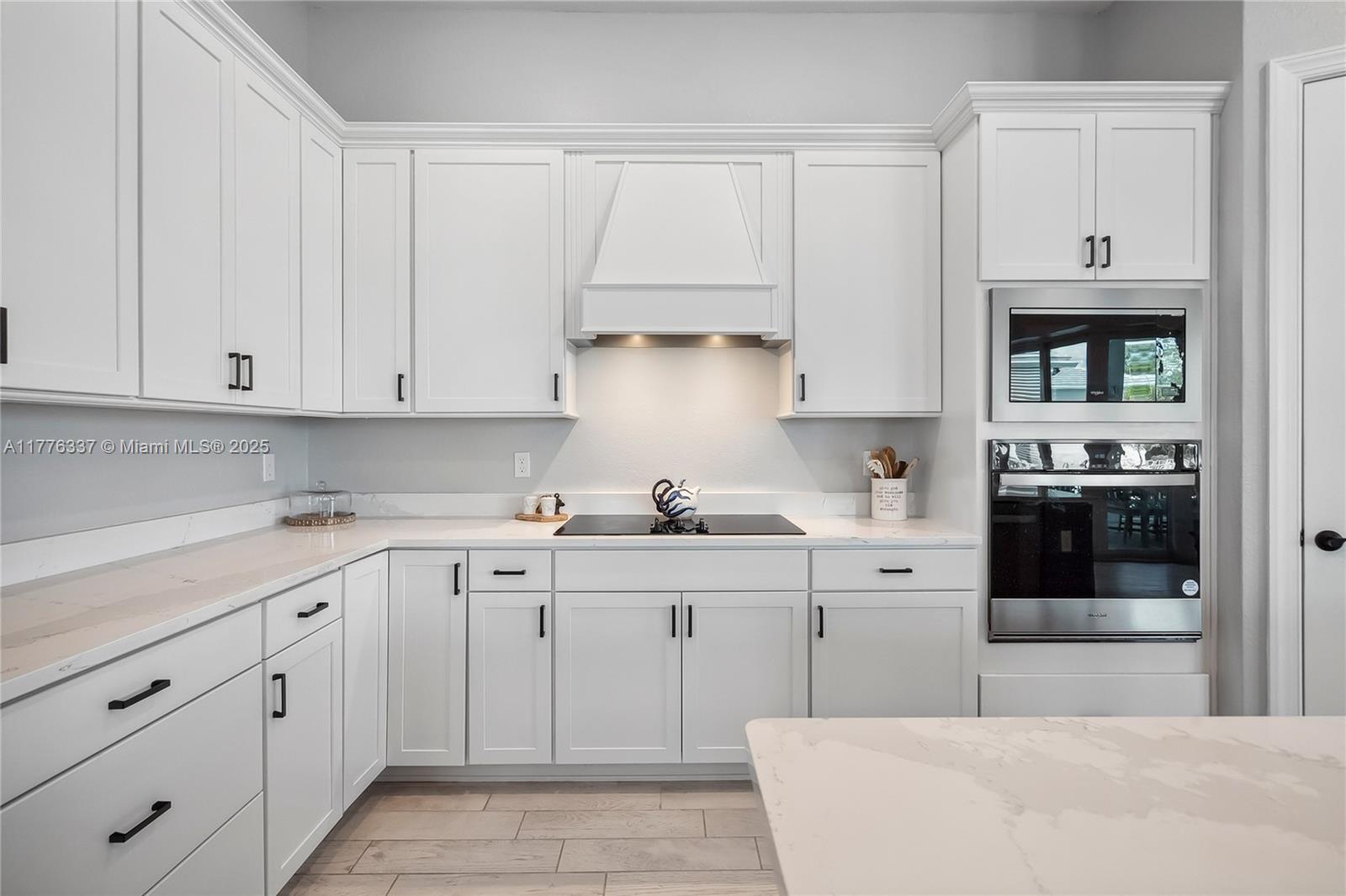 9734 Southwest Meridian Way Stuart, FL 34997 - Photo 9 of 48 a kitchen with cabinets appliances a sink and a counter space