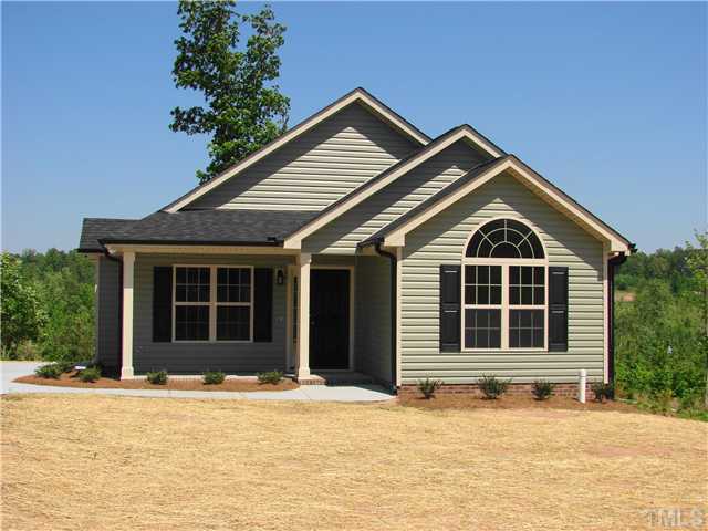 103 Orkney Road, Unit LOT60 Stem, NC 27581 - Photo 1 of 3 a front view of a house with a yard