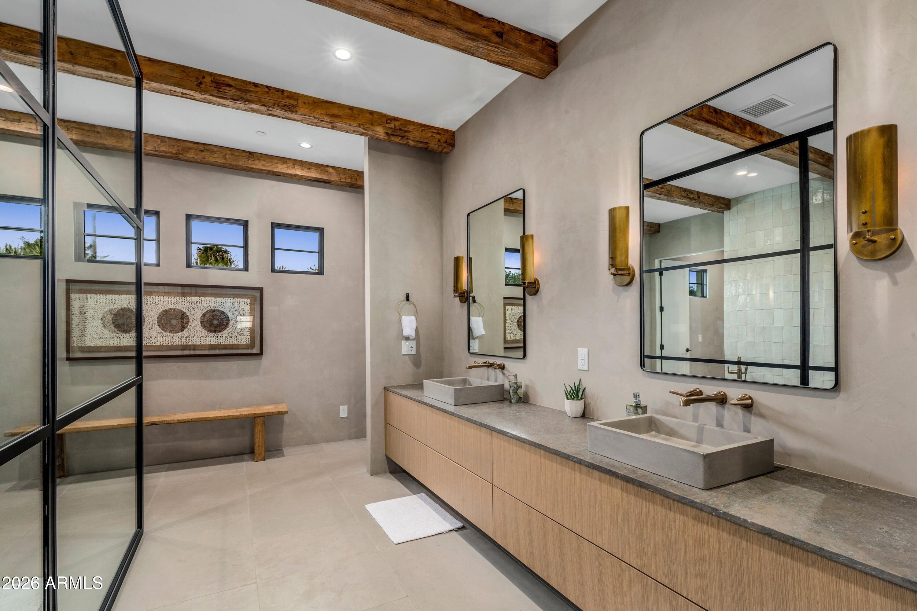 8307 East Gary Road Scottsdale, AZ 85260 - Photo 13 of 34 a bathroom with double vanity sink and a mirror