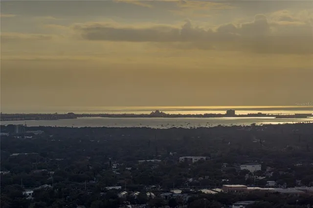 a large bedroom with a large bed and glass window