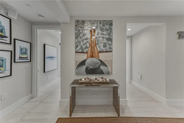 a living room with furniture and large windows