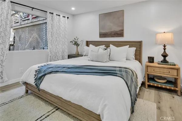 a bedroom with a bed and a window