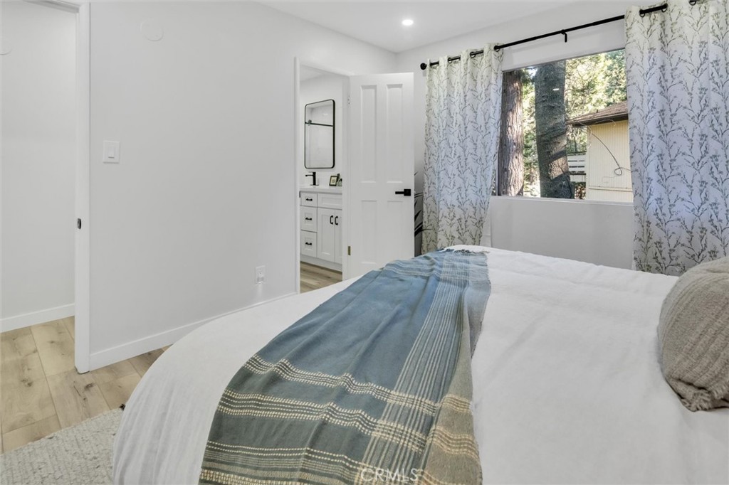 377 Hillside Road Lake Arrowhead, CA 92352 - Photo 12 of 33 a bedroom with a bed and a window
