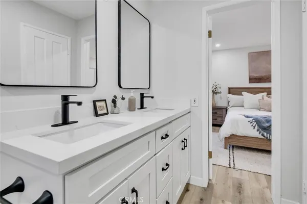 a bathroom with a toilet sink double vanity and shower