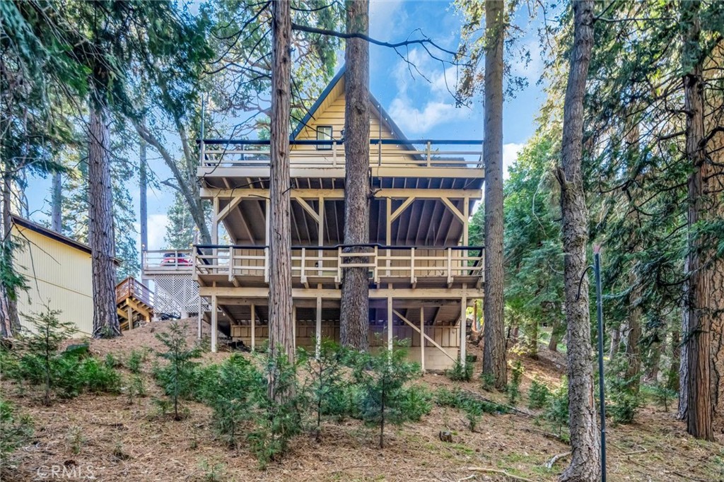 377 Hillside Road Lake Arrowhead, CA 92352 - Photo 28 of 33 a view of a brick house with large windows and a tree