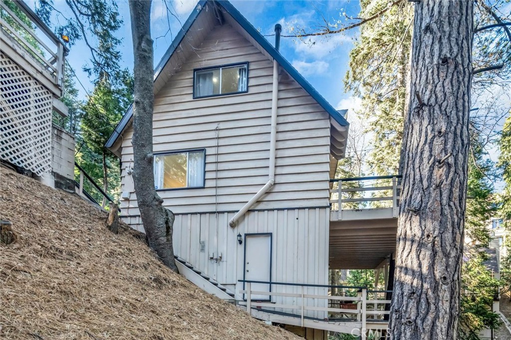 377 Hillside Road Lake Arrowhead, CA 92352 - Photo 30 of 33 a view of house with a tree and wooden fence