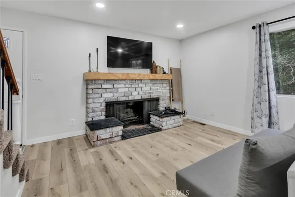 a living room with a fireplace and a flat screen tv