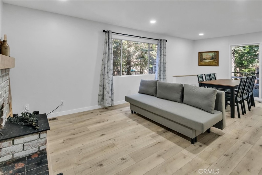 377 Hillside Road Lake Arrowhead, CA 92352 - Photo 5 of 33 a living room with furniture and a large window