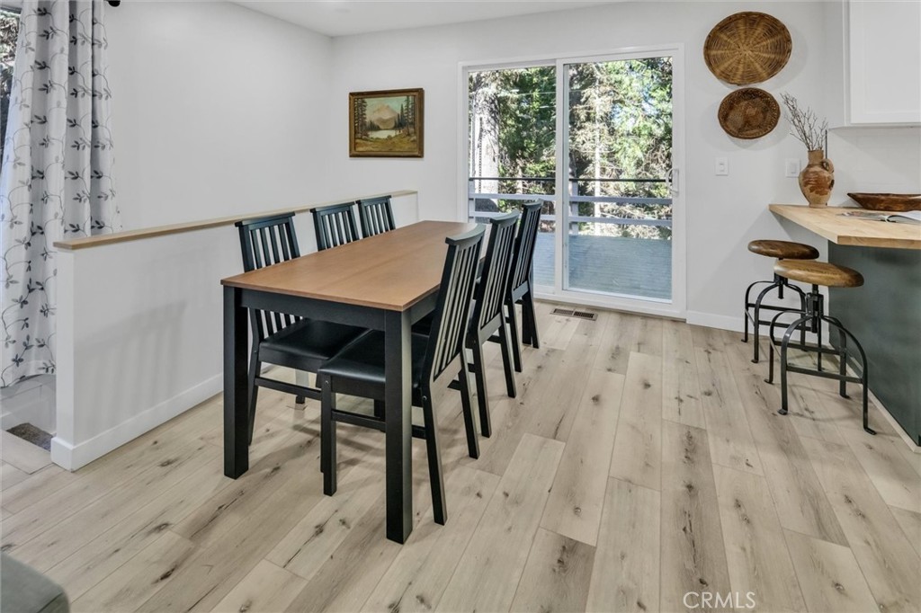377 Hillside Road Lake Arrowhead, CA 92352 - Photo 6 of 33 a view of a dining room with furniture and a window