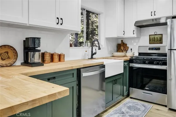 a kitchen with kitchen island sink refrigerator and stove