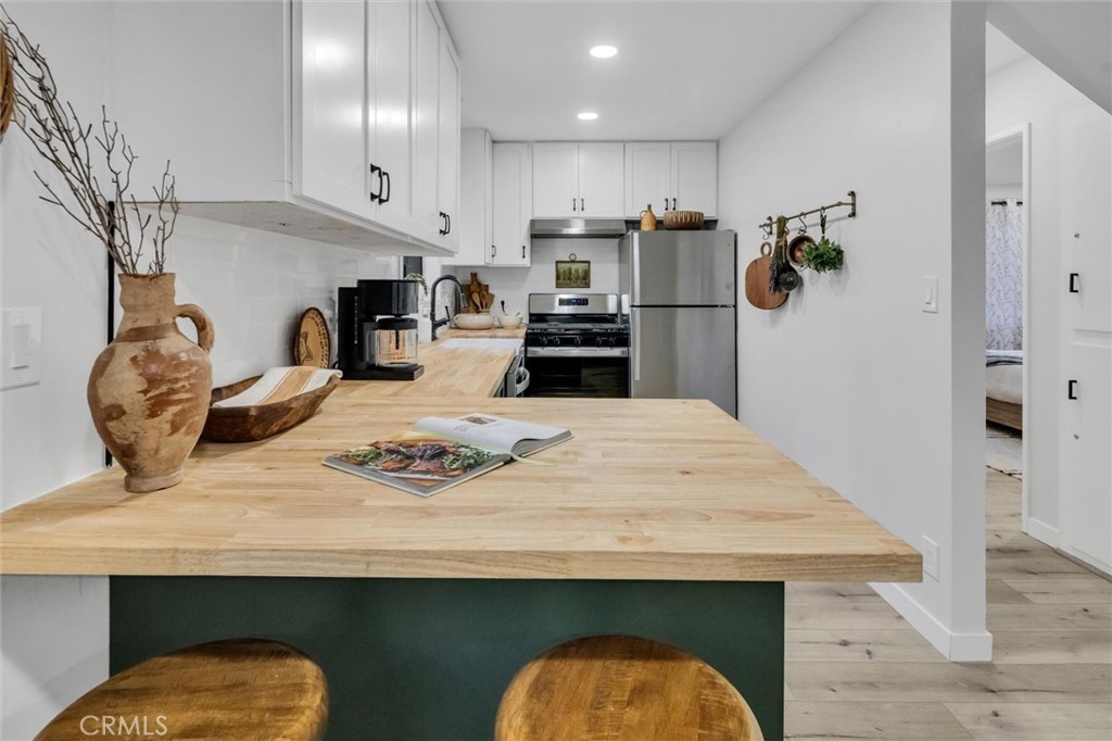 377 Hillside Road Lake Arrowhead, CA 92352 - Photo 9 of 33 a kitchen with kitchen island sink refrigerator and stove