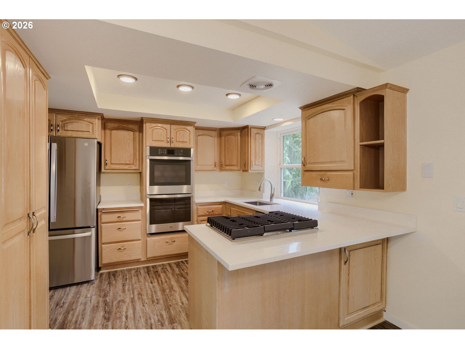 14539 Southeast Center Street Portland, OR 97236 - Photo 9 of 30 a kitchen view with stainless steel appliances a refrigerator and a stove top oven