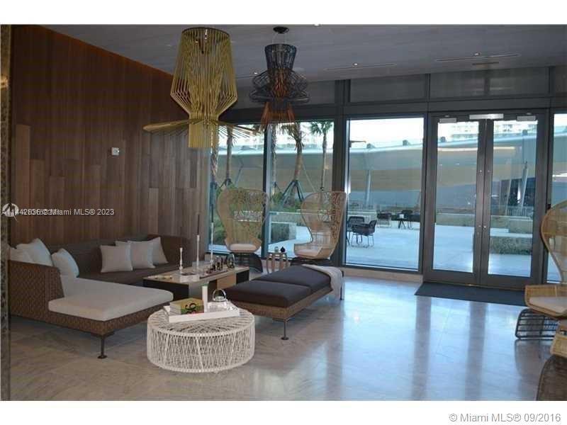 68 Southeast 6th Street, Unit 3510 Miami, FL 33131 - Photo 3 of 19 a living room with furniture and a floor to ceiling window