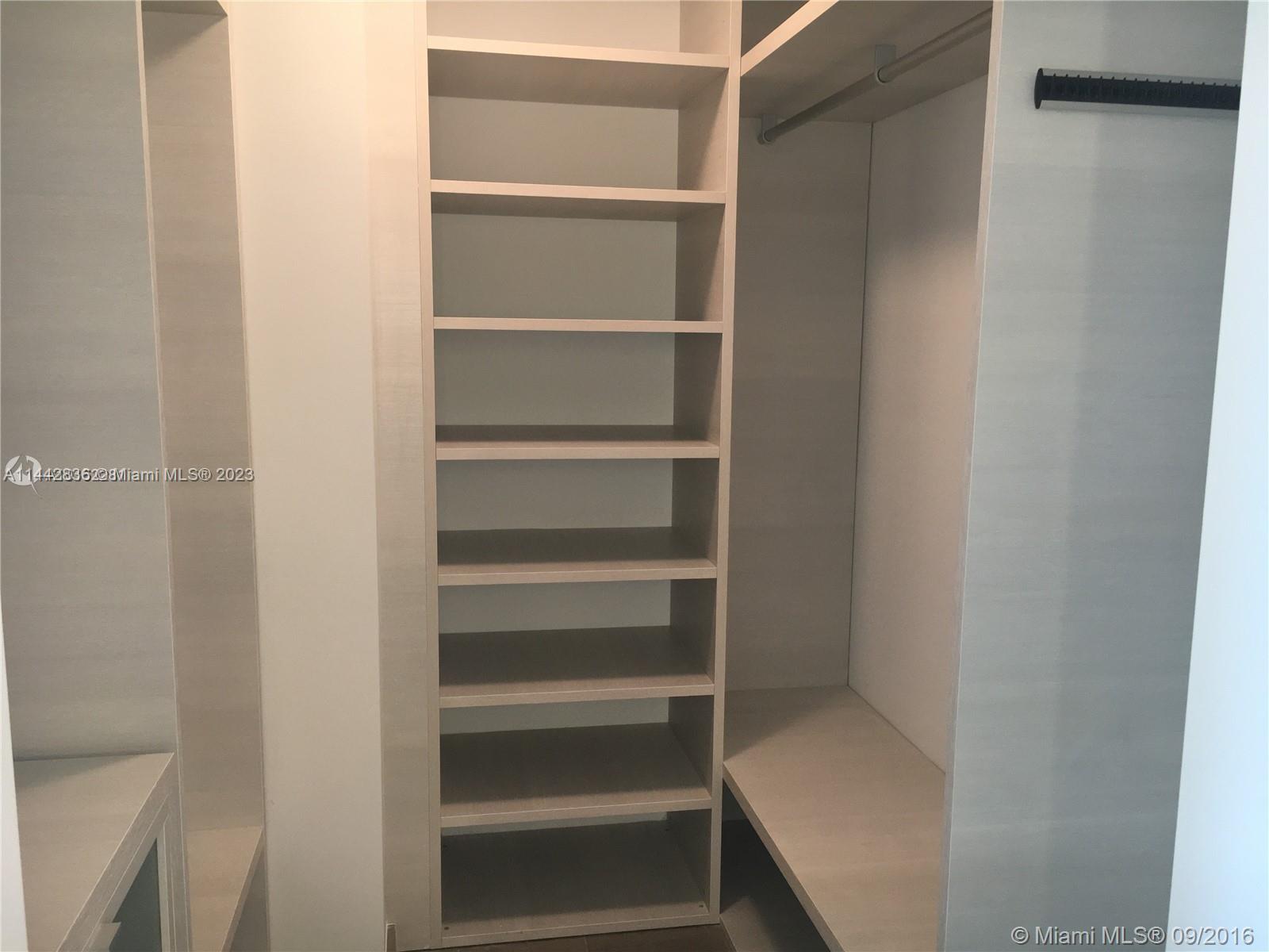 68 Southeast 6th Street, Unit 3510 Miami, FL 33131 - Photo 5 of 19 a view of walk in closet with empty racks