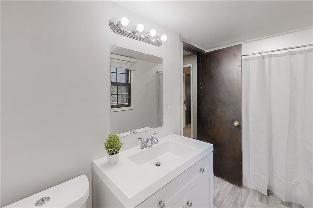 2284 Emerald Springs Drive Decatur, GA 30035 - Photo 5 of 30 a bathroom with a sink a toilet and mirror
