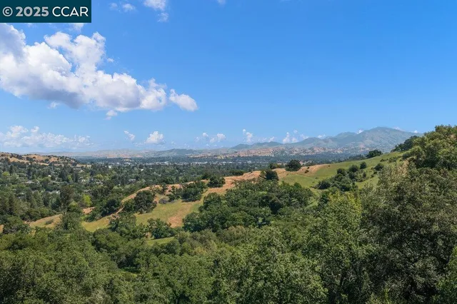 an aerial view of residential house with outdoor space and trees all around