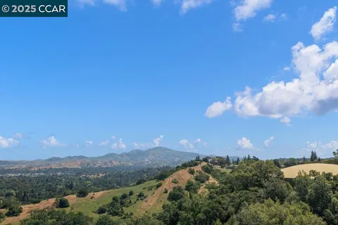 an aerial view of residential house with outdoor space and trees