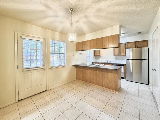 a kitchen with stainless steel appliances granite countertop a refrigerator and a sink