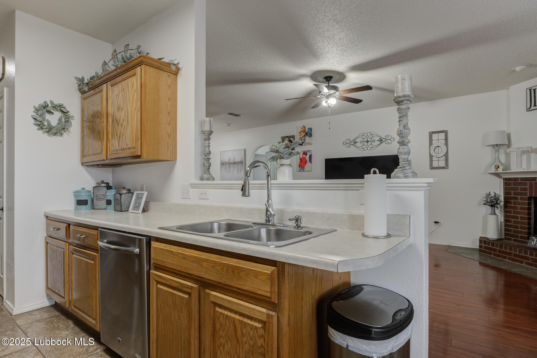 6223 18th Street Lubbock, TX 79416 - Photo 12 of 29 a kitchen with a sink a stove and a wooden floor