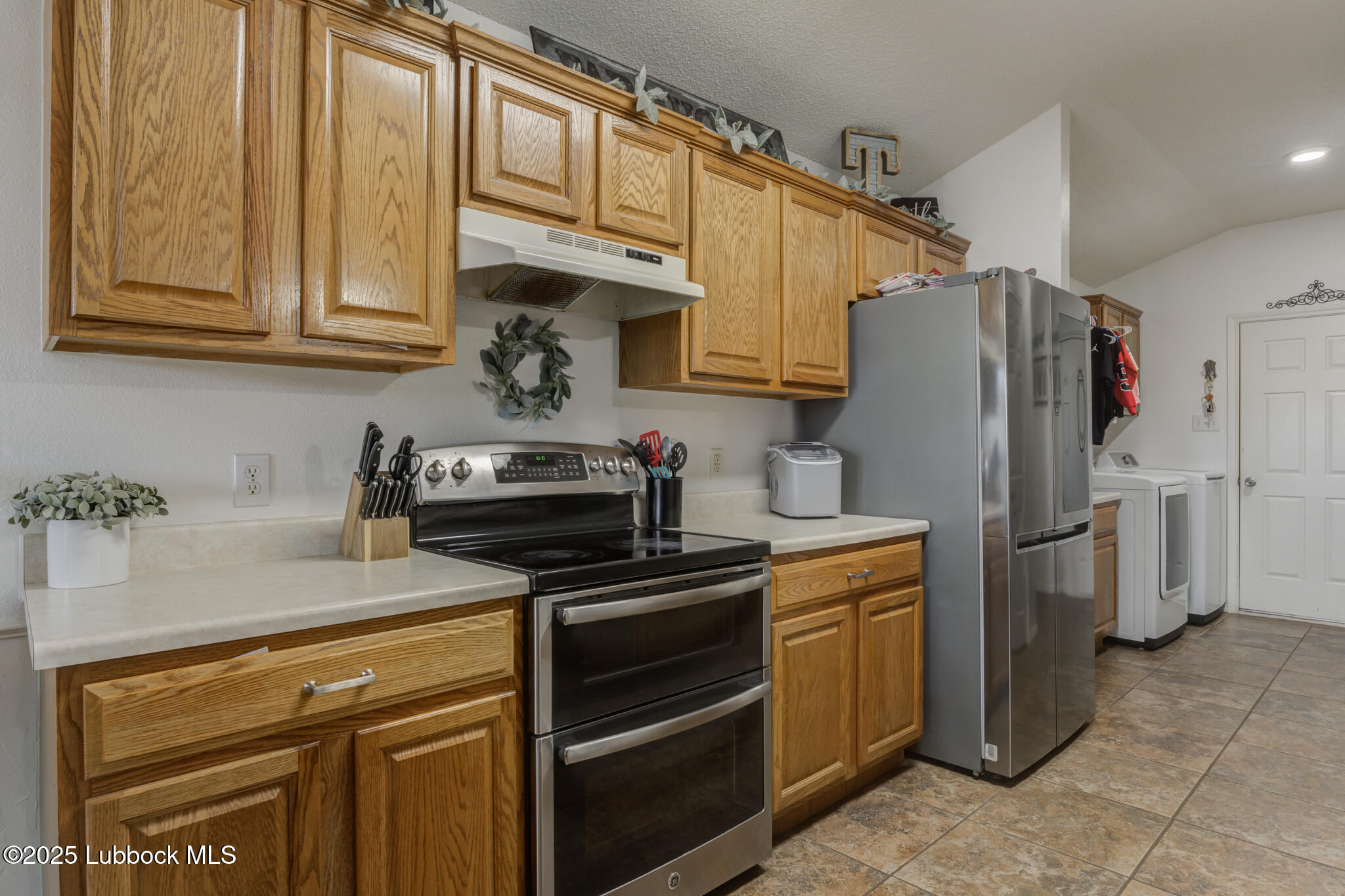 6223 18th Street Lubbock, TX 79416 - Photo 13 of 29 a kitchen with stainless steel appliances granite countertop a refrigerator stove and sink