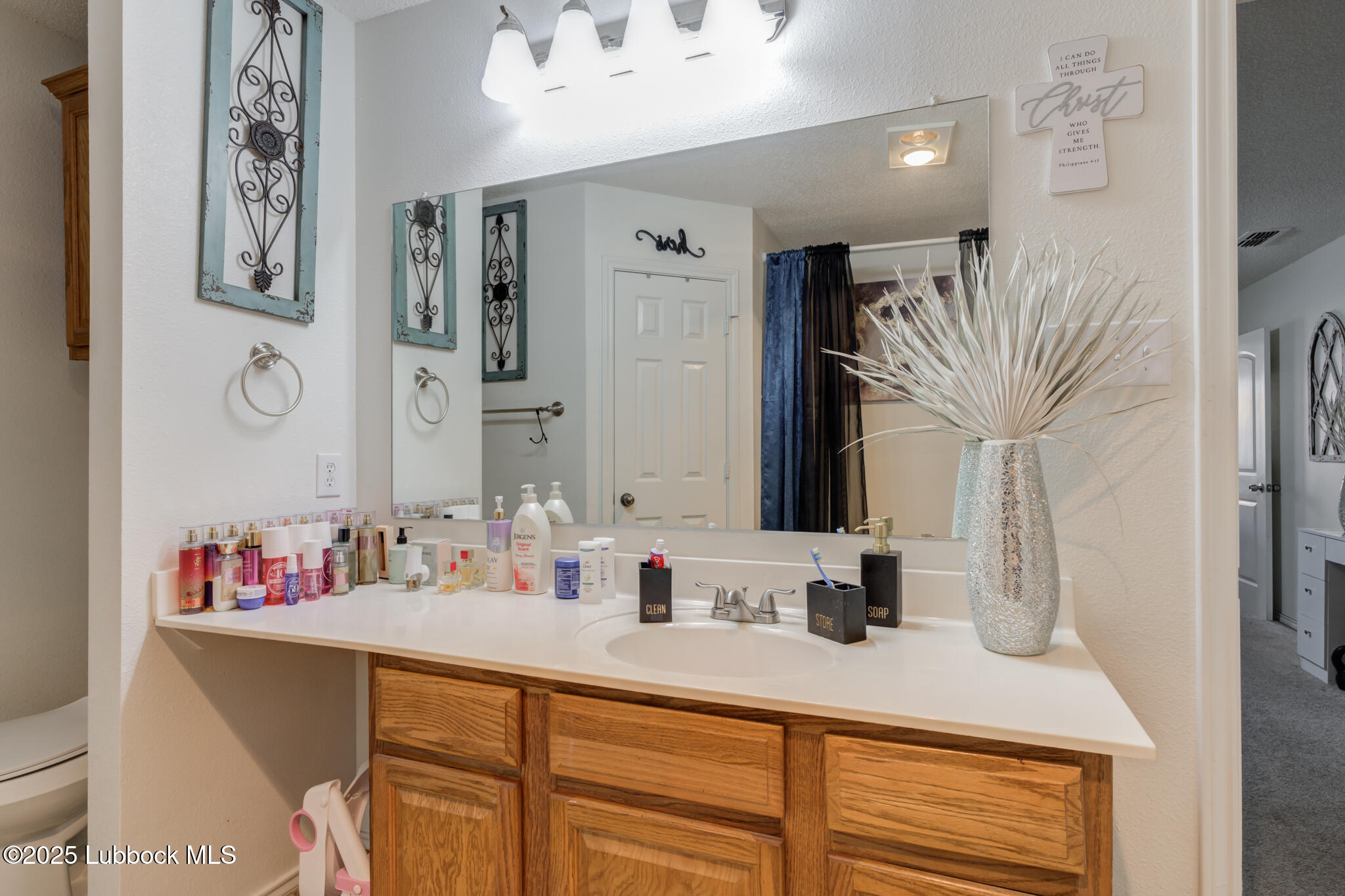 6223 18th Street Lubbock, TX 79416 - Photo 20 of 29 a bathroom with a sink vanity and mirror