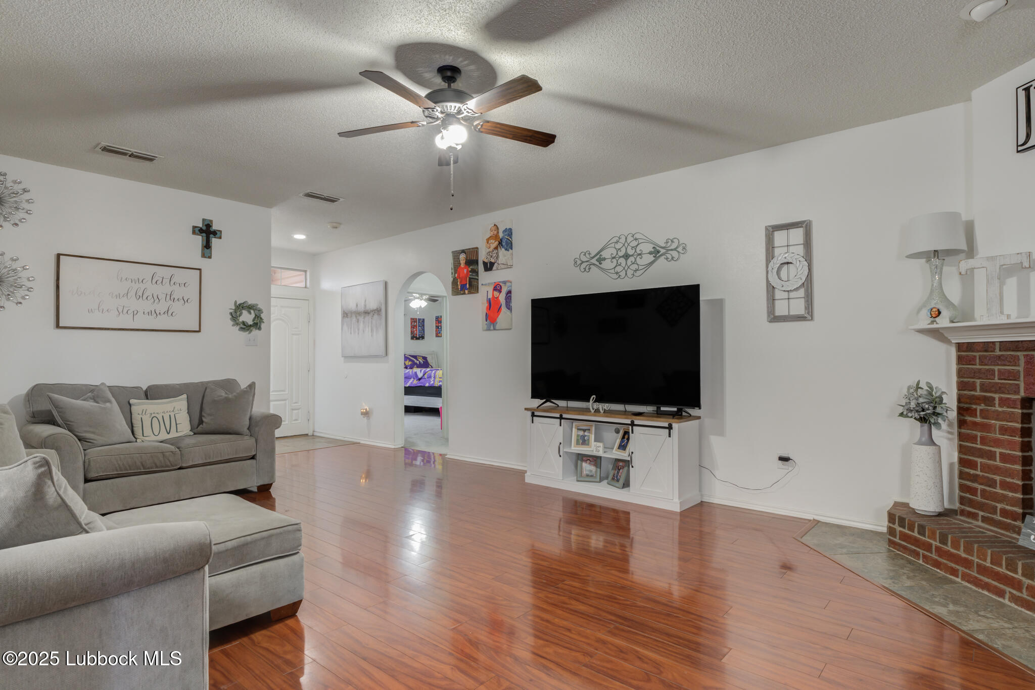 6223 18th Street Lubbock, TX 79416 - Photo 7 of 29 a living room with furniture and a flat screen tv