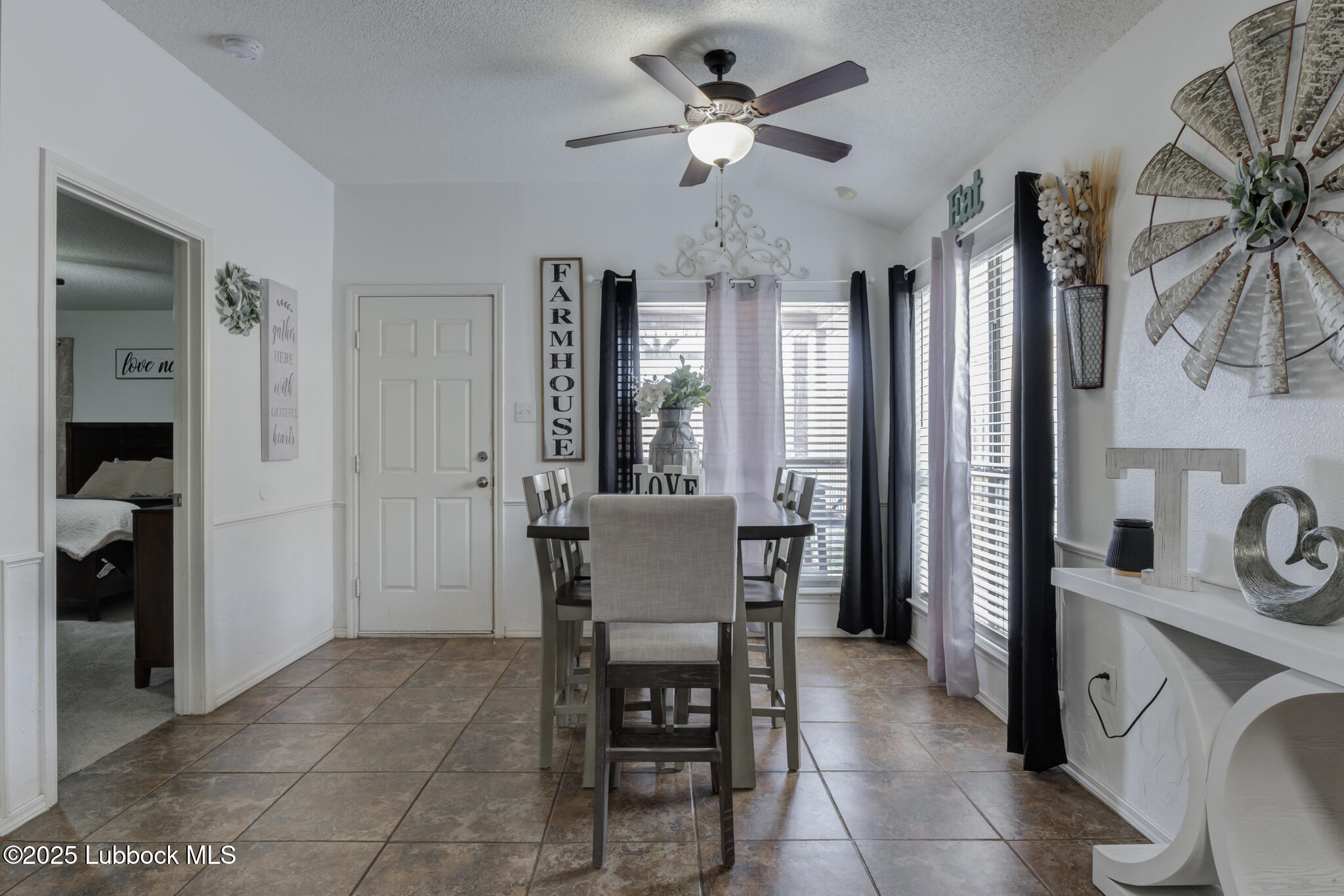 6223 18th Street Lubbock, TX 79416 - Photo 10 of 29 a view of a dining room with furniture and a chandelier fan