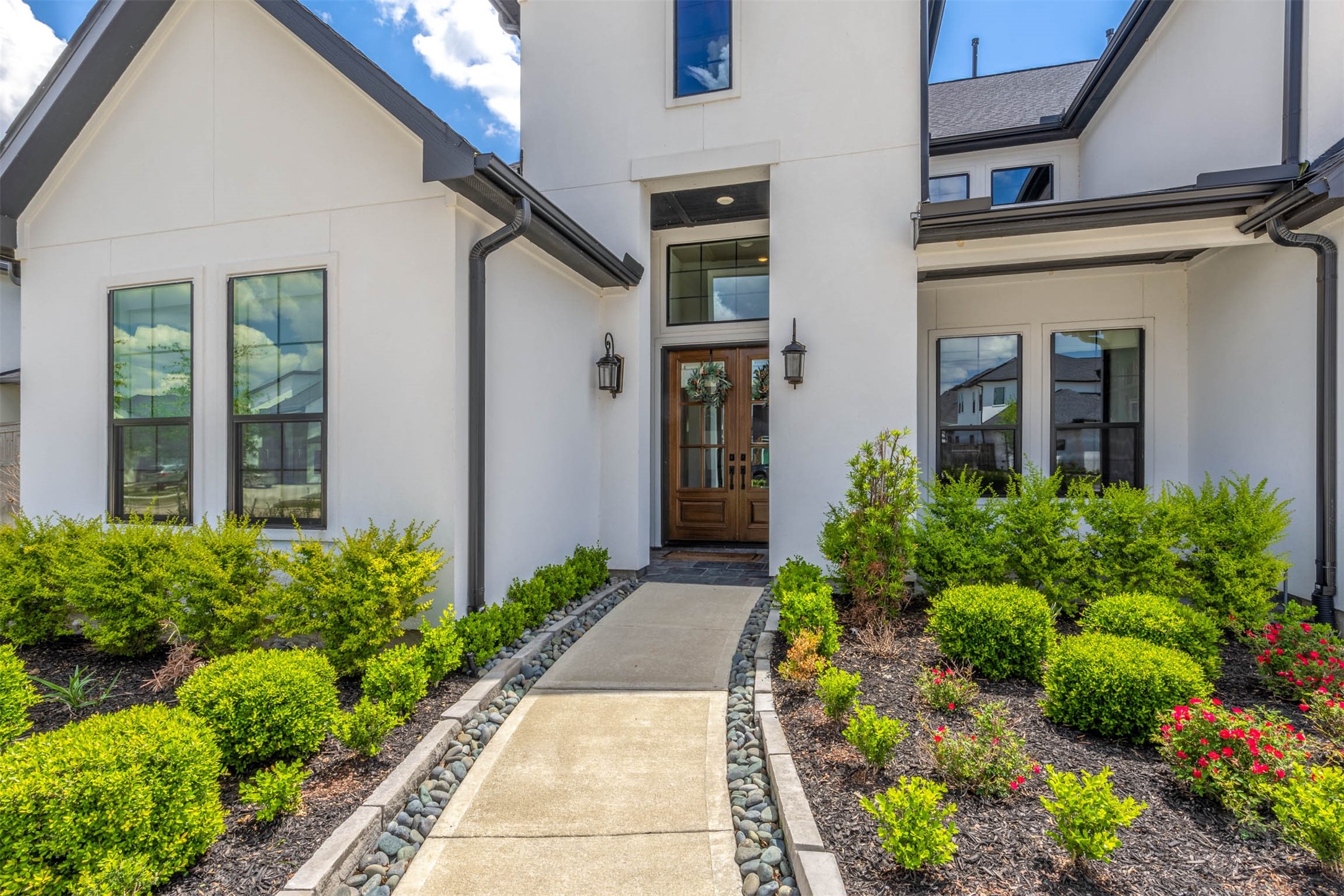 27919 Indigo Ridge Drive Fulshear, TX 77441 - Photo 50 of 50 The stunning stucco front elevation including gorgeous professional landscaping creates a gorgeous A+ curb appeal! When you walk in through the double door entry, every view and designer finish will take your breath away.