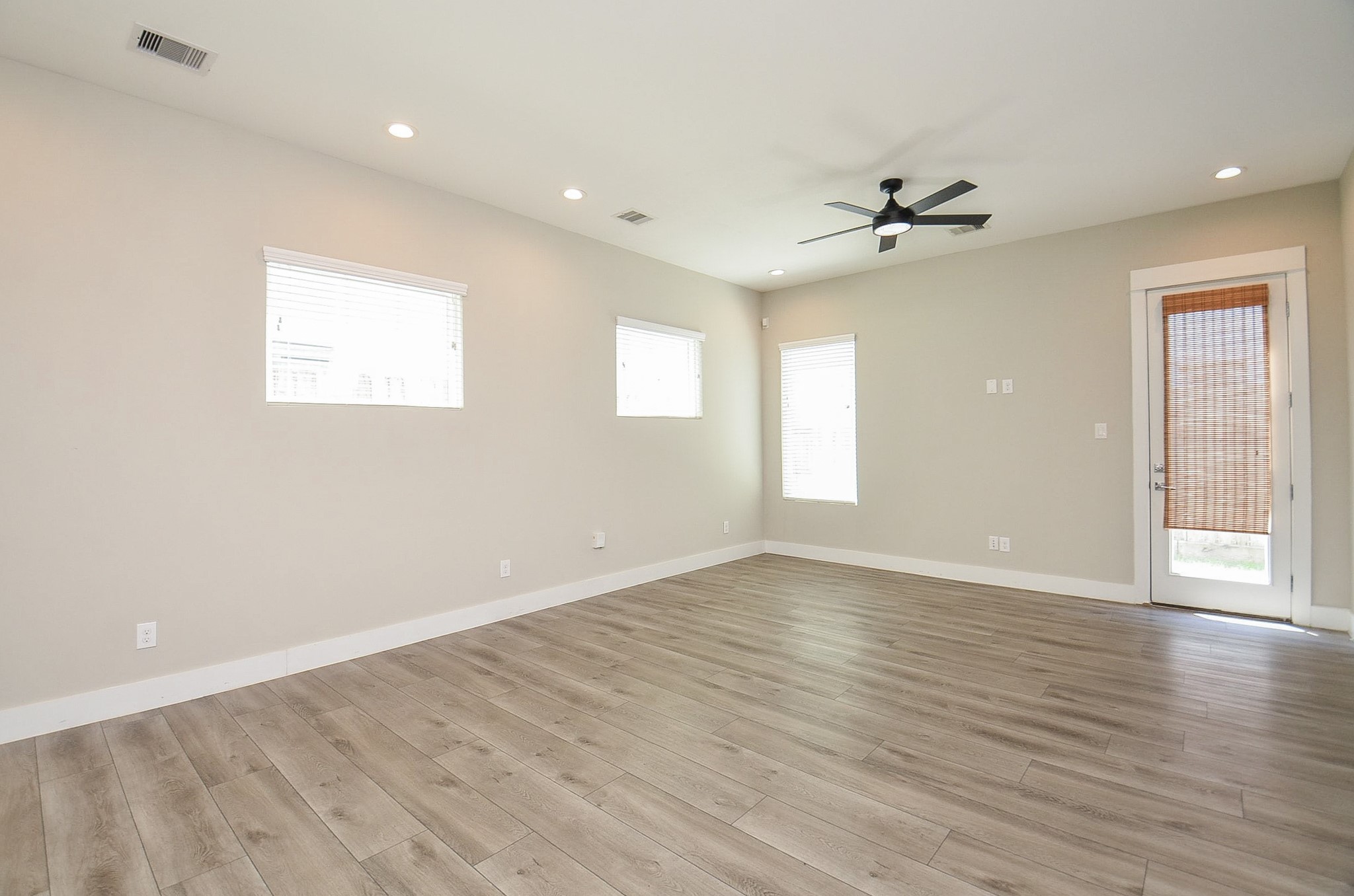 1223 West Tidwell Road Houston, TX 77091 - Photo 12 of 30 Multiple windows bring in natural light in the living room with convenient access door leading directly to the side patio and yard.