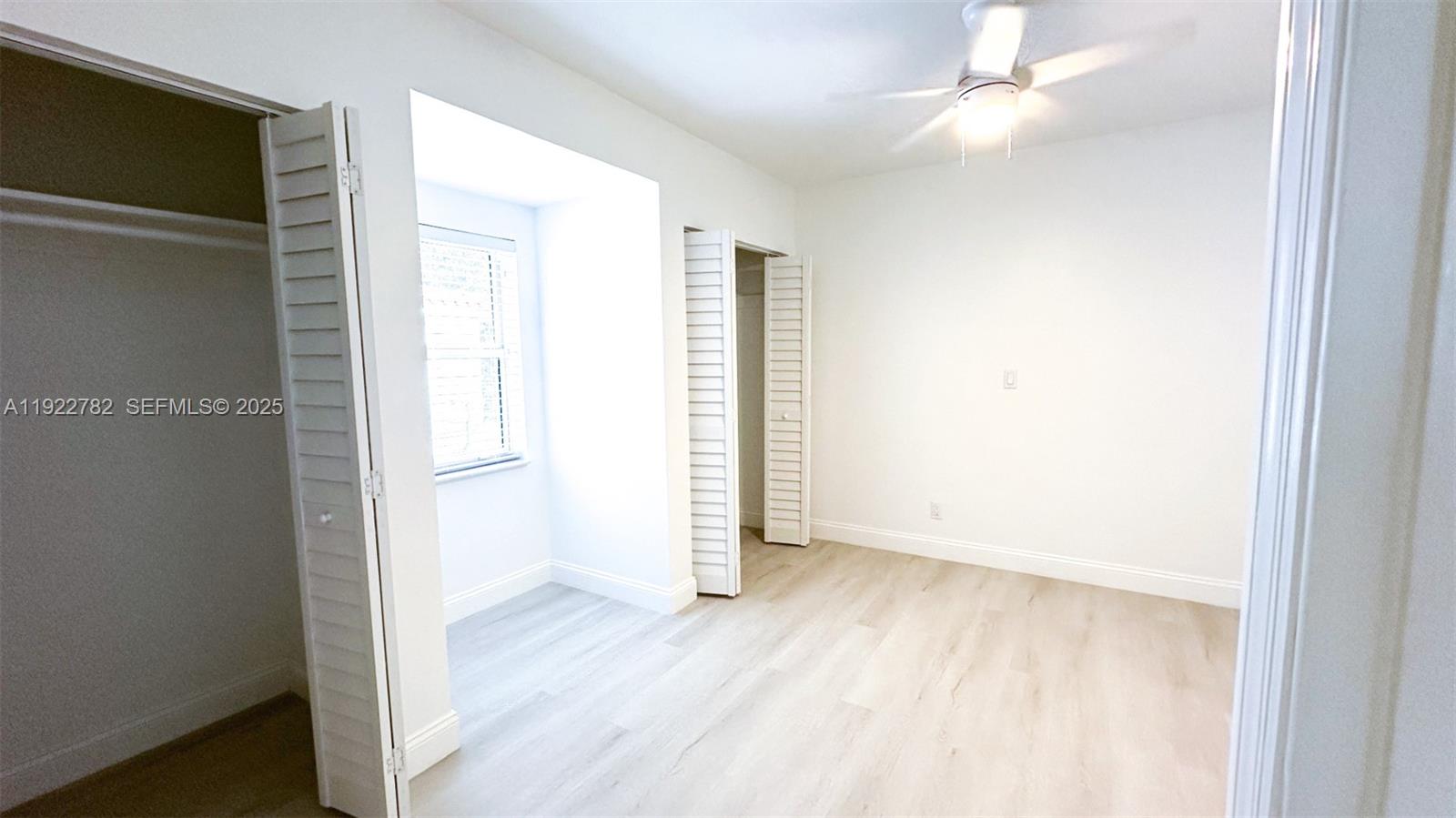 2240 Southwest 16th Court, Unit U Miami, FL 33145 - Photo 12 of 22 an empty room with wooden floor closet and windows