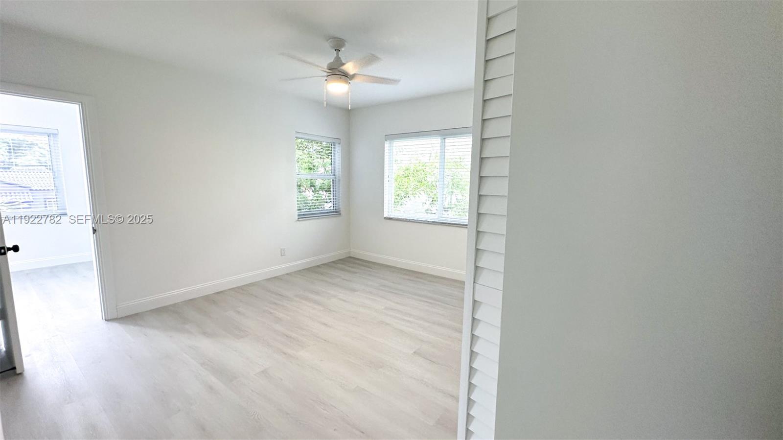 2240 Southwest 16th Court, Unit U Miami, FL 33145 - Photo 14 of 22 an empty room with windows and fan