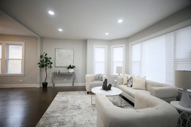 a living room with furniture and a potted plant