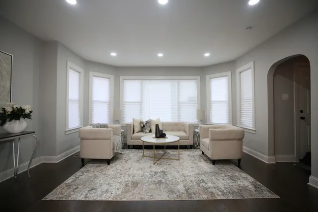 a living room with furniture and a potted plant