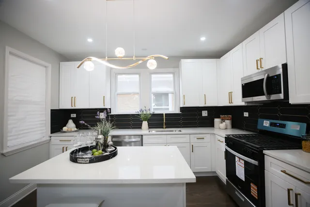 a kitchen with a sink a stove and cabinets