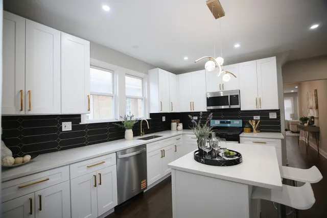 a kitchen with sink a stove and cabinets