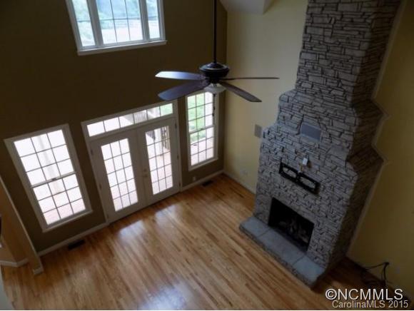 418 Chisholm Trail Rutherfordton, NC 28139 - Photo 11 of 22 a living room with furniture a fireplace and a floor to ceiling window