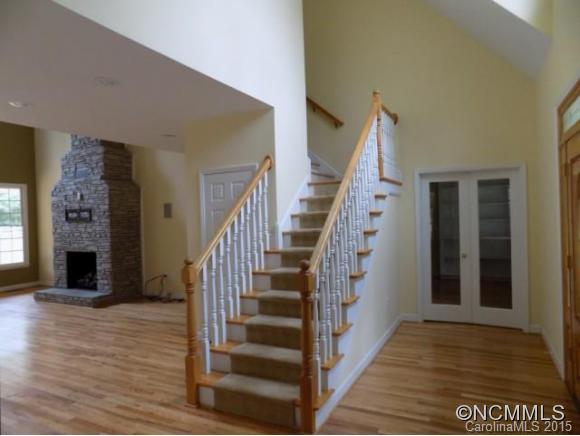 418 Chisholm Trail Rutherfordton, NC 28139 - Photo 12 of 22 a view of a hallway with wooden floor fireplace and windows
