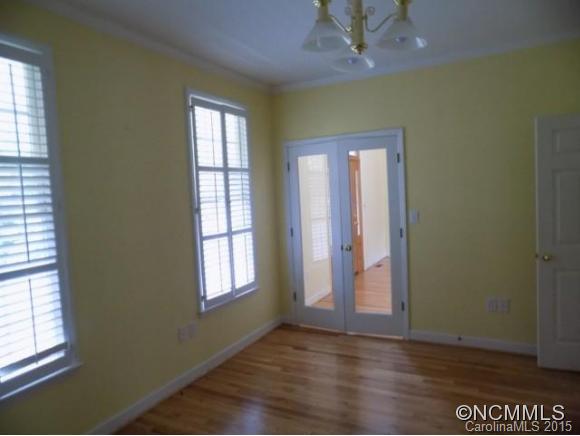 418 Chisholm Trail Rutherfordton, NC 28139 - Photo 14 of 22 an empty room with wooden floor and windows