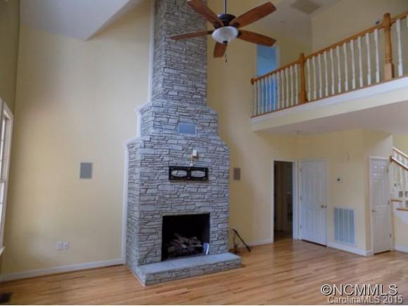 418 Chisholm Trail Rutherfordton, NC 28139 - Photo 4 of 22 a living room with a fireplace and a wooden floor