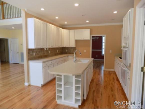 418 Chisholm Trail Rutherfordton, NC 28139 - Photo 5 of 22 a kitchen with kitchen island granite countertop a sink and refrigerator