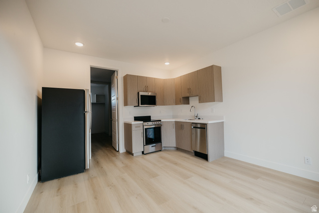 2759 Becco Trail, Unit 16 St. George, UT 84770 - Photo 36 of 42 Kitchen with stainless steel appliances, modern cabinets, light wood finished floors, recessed lighting, and light brown cabinets