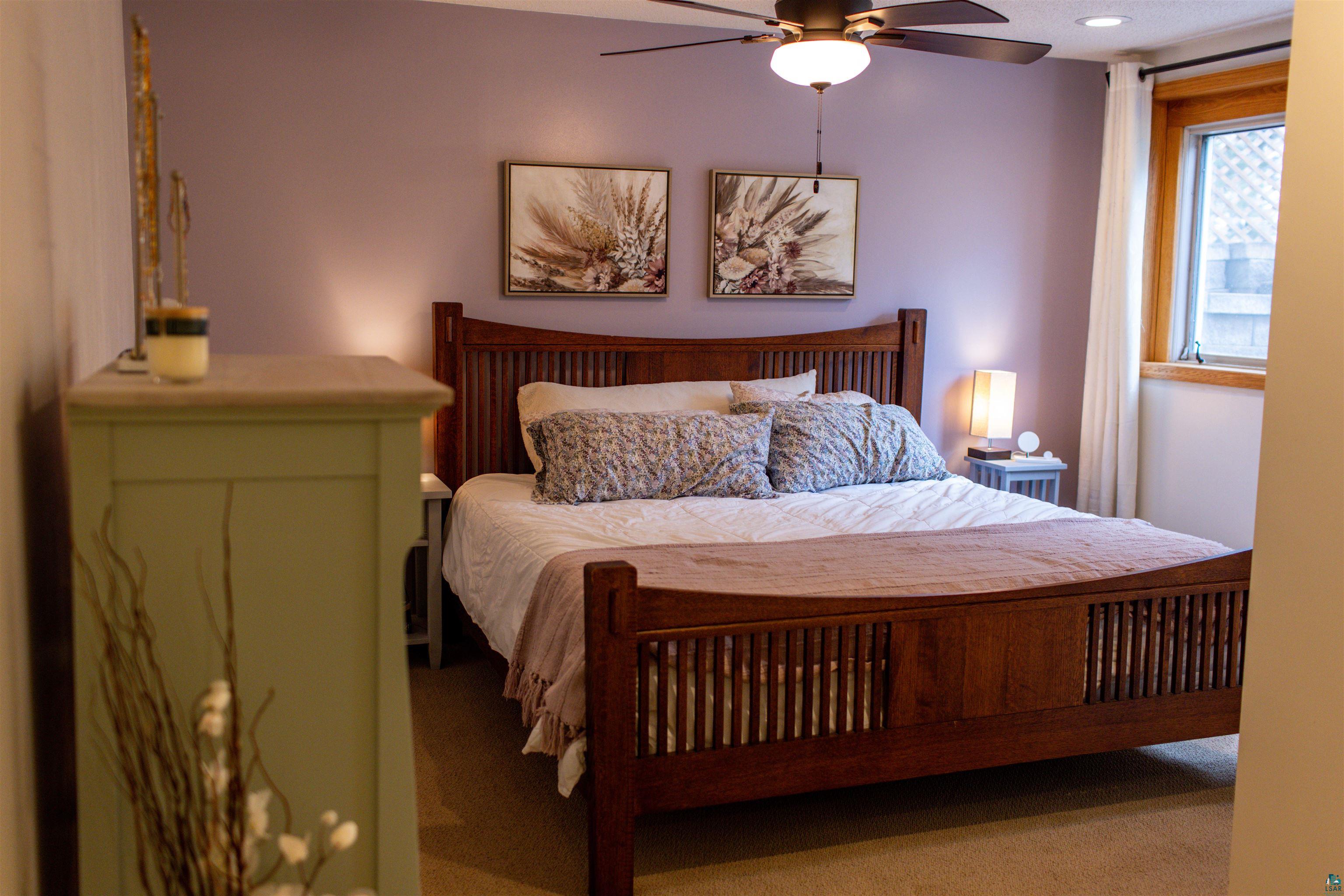 3704 Greysolon Road Duluth, MN 55804 - Photo 27 of 51 Spacious room featuring a ceiling fan with integrated lighting, wood-frame window with white curtains, recessed lighting, and soft carpet flooring