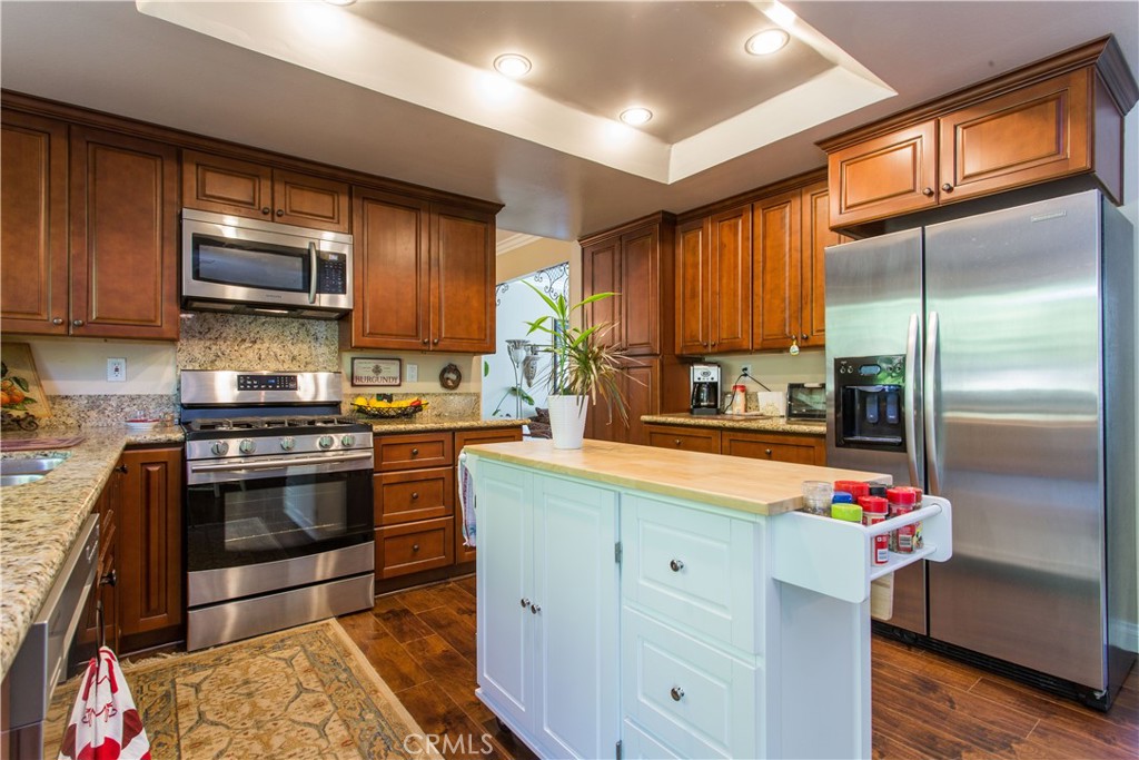 30311 Goodspring Drive Agoura Hills, CA 91301 - Photo 6 of 18 a kitchen with stainless steel appliances granite countertop a refrigerator a stove and a sink