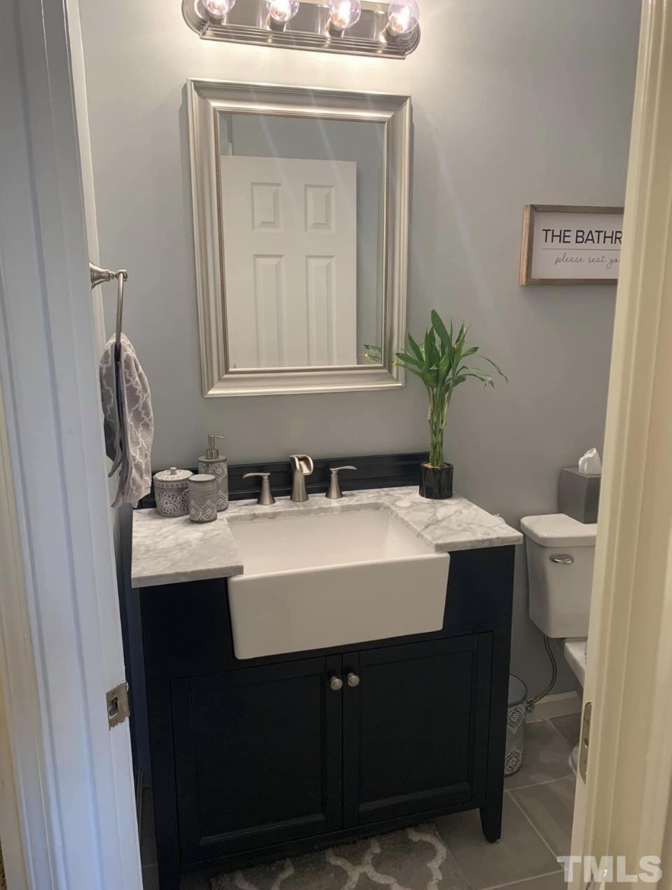 1206 Maroon Drive Durham, NC 27713 - Photo 6 of 11 a bathroom with a sink and a mirror