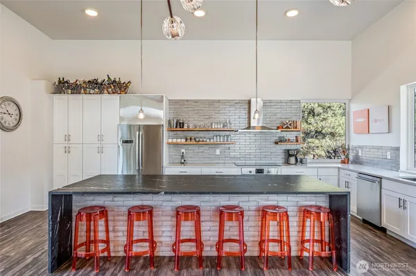 a kitchen with stainless steel appliances granite countertop a sink and a stove