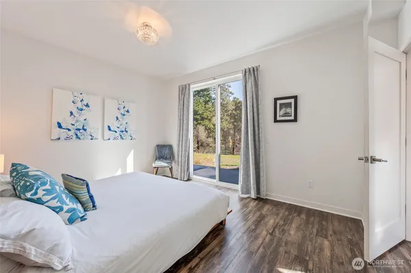 a bed sitting in a bedroom next to a window